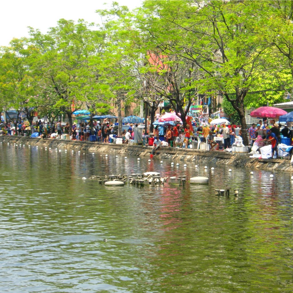 people along the river in chiang mai during songkran