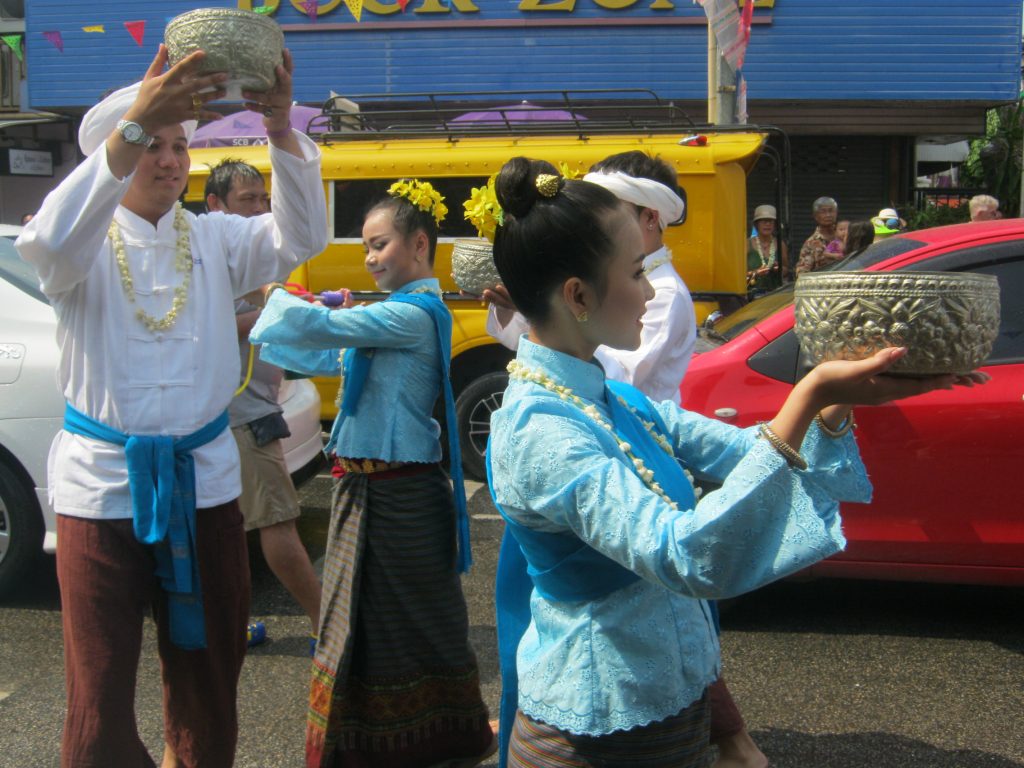 carrying baskets at songkran