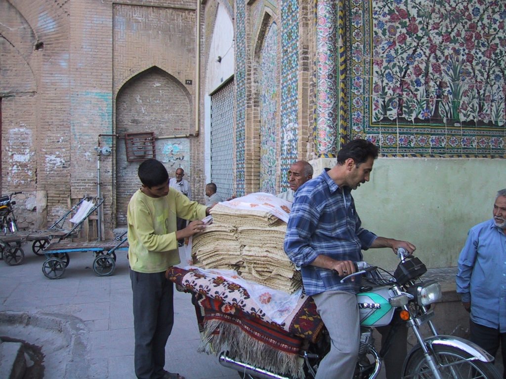 Men delivering goods on a motorcycle in Iran