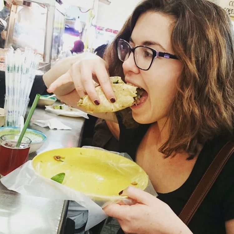 traveller eating a taco in Mexico City