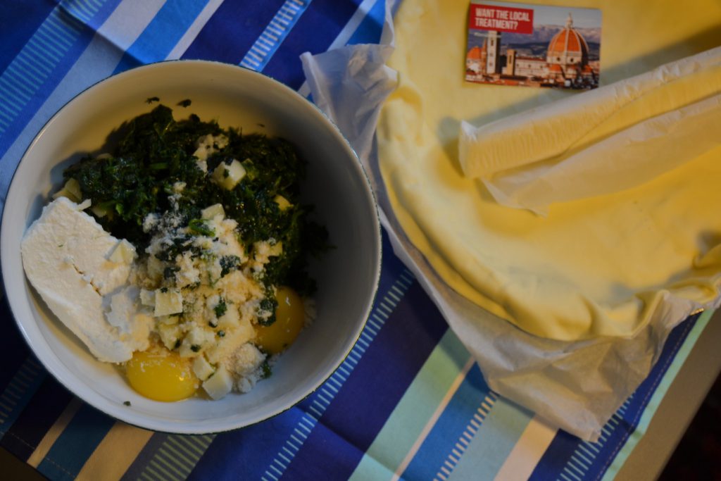 bowl of spinach and cheese ready for making a torta