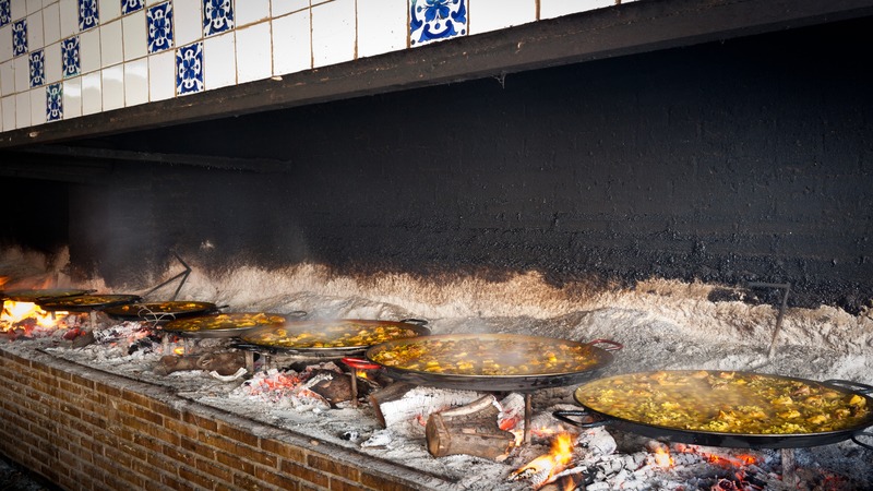 pans of paella cooking
