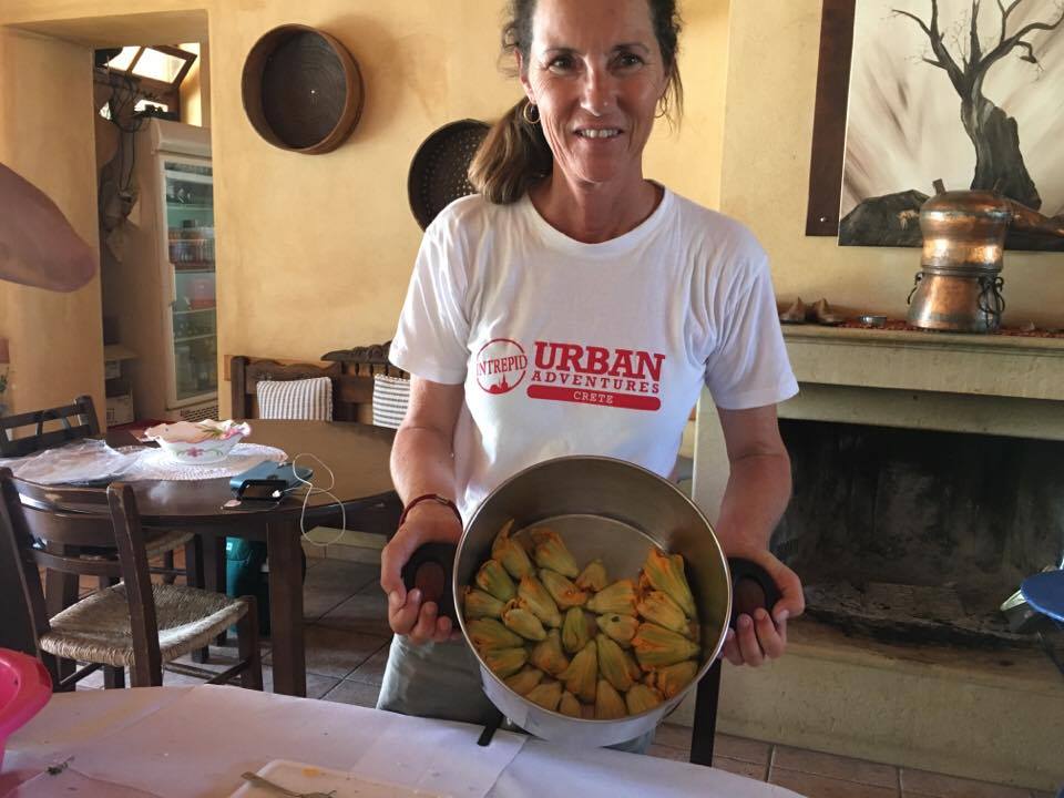 guide holding a pot of stuffed zucchinis