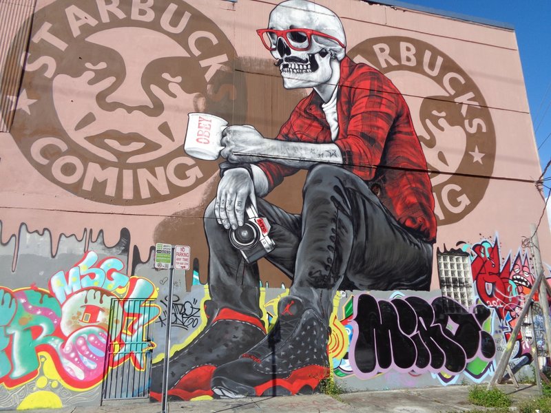 street art of a skeleton drinking coffee