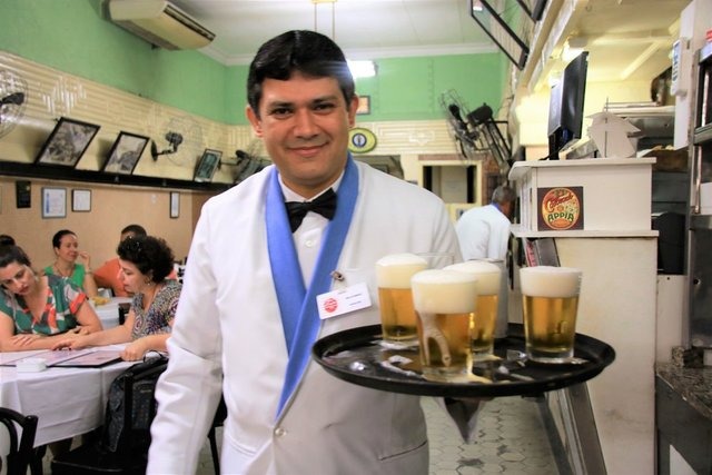 bartender carrying beers