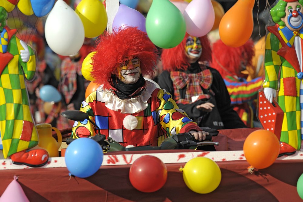 clown surrounded by balloons